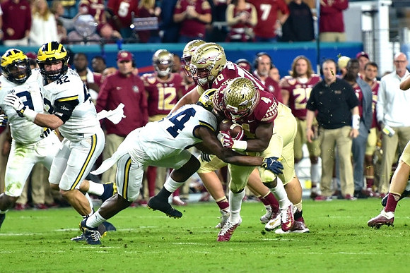Mike McCray (9), Ben Gedeon (42), and Josh Metellus (14)