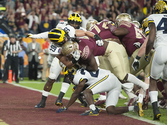 Mike McCray (9), Noah Furbush (59), Jourdan Lewis (26), and Delano Hill (44)