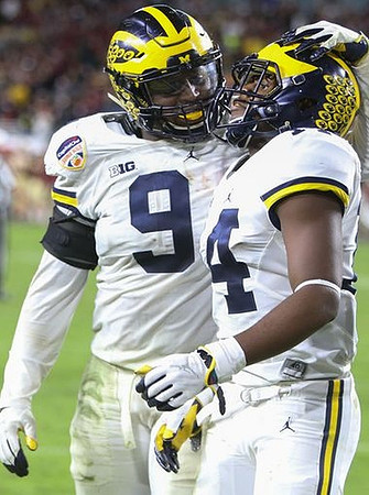 Mike McCray (9) and Josh Metellus (14)