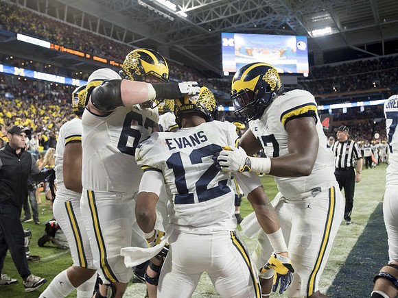 Chris Evans (12), Kyle Kalis (67), and Tyrone Wheatley Jr. (17)