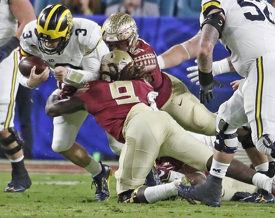 Wilton Speight (3) and Mason Cole (52)