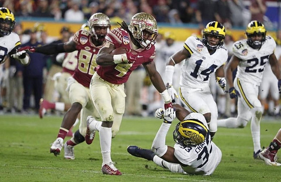 Taco Charlton (33), Josh Metellus (14), and Dymonte Thomas (25)