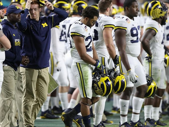 Tyree Kinnel (23) and Michigan Team