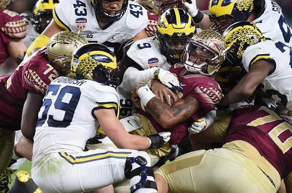 Chris Wormley (43), Noah Furbush (59), Mike McCray (9), and Ben Gedeon (42)