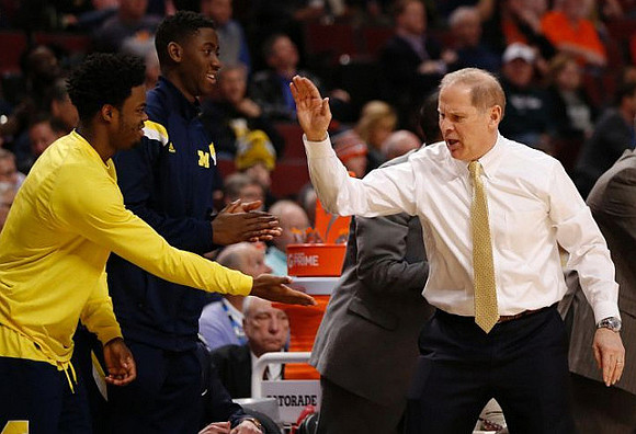 Derrick Walton Jr. (10), Caris LeVert (23), and John Beilein