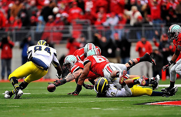 A.J. Williams (84) and Denard Robinson (16)