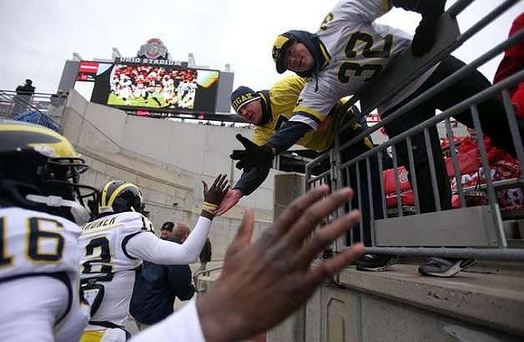 Denard Robinson (16) and Devin Gardner (12)