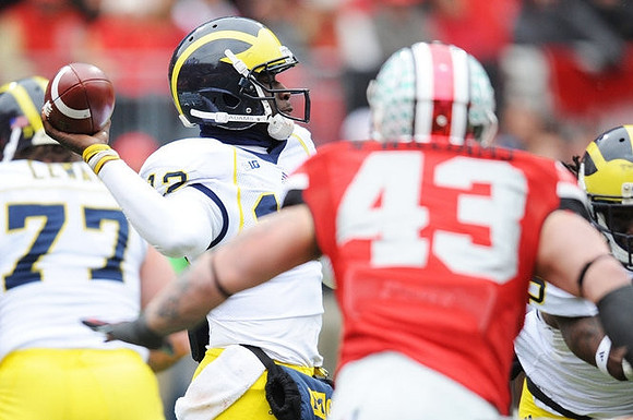 Taylor Lewan (77) and Devin Gardner (12)