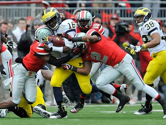 Stephen Hopkins (33), Denard Robinson (16), and Thomas Rawls (38)