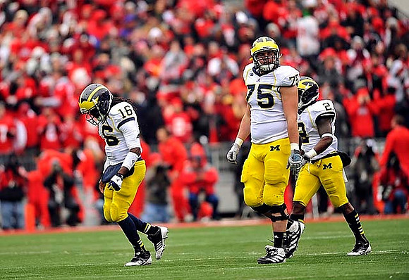 Denard Robinson (16), Michael Schofield (75), and Vincent Smith (2)