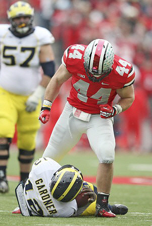 Elliott Mealer (57) and Devin Gardner (12)