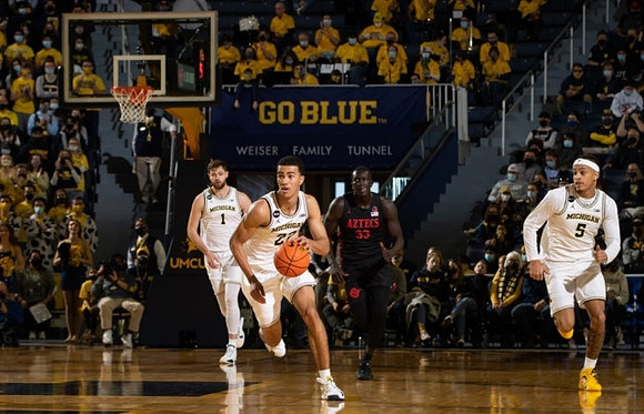 Hunter Dickinson (1), Caleb Houstan (22), and Terrance Williams II (5)