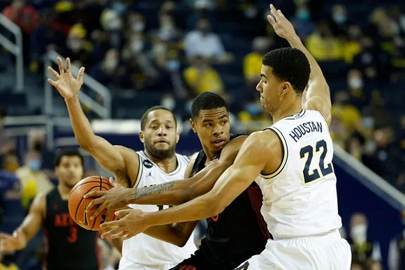 DeVante' Jones (12) and Caleb Houstan (22)
