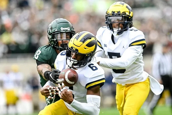 Cornelius Johnson (6) and Mike Sainristil (5)