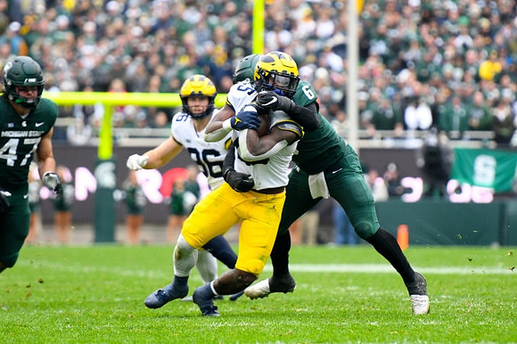 Luke Schoonmaker (86) and Hassan Haskins (25)