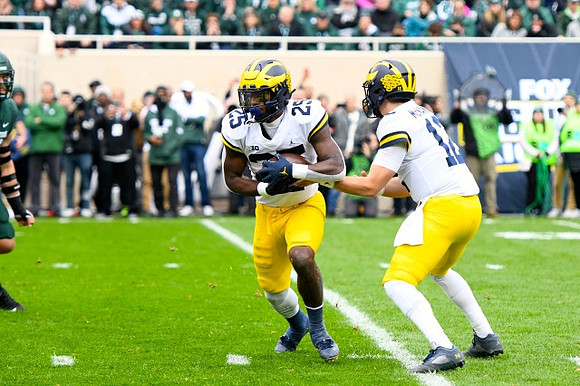 Hassan Haskins (25) and Cade McNamara (12)