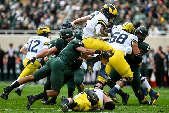 Cade McNamara (12), Blake Corum (2), and Andrew Vastardis (68)