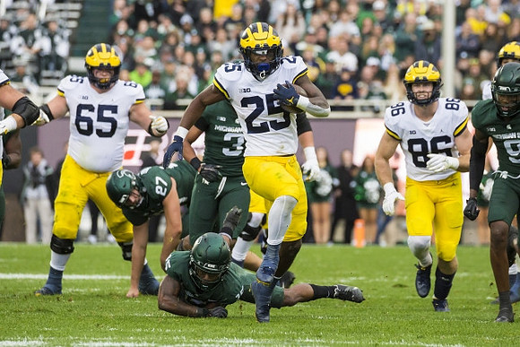 Zak Zinter (65), Hassan Haskins (25), and Luke Schoonmaker (86)