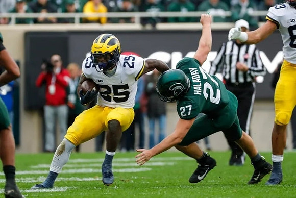 Hassan Haskins (25) and Erick All (83)