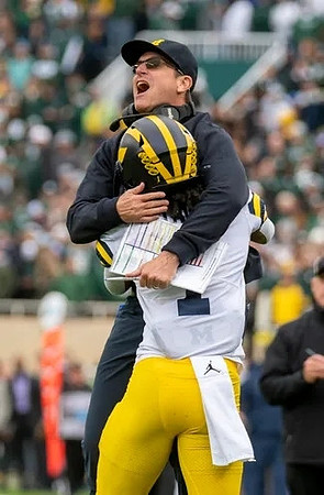 Andrel Anthony (1) and Jim Harbaugh