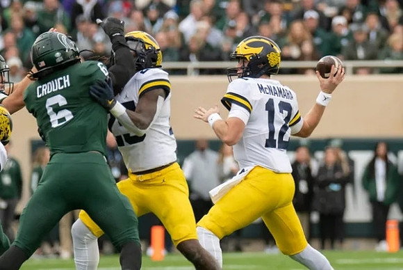 Hassan Haskins (25) and Cade McNamara (12)