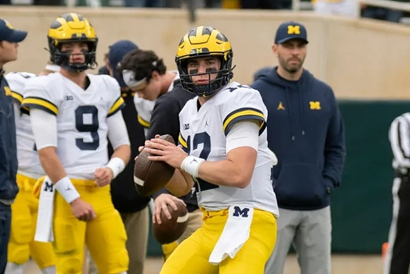 J.J. McCarthy (9) and Cade McNamara (12)