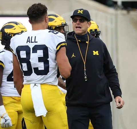 Erick All (83) and Jim Harbaugh