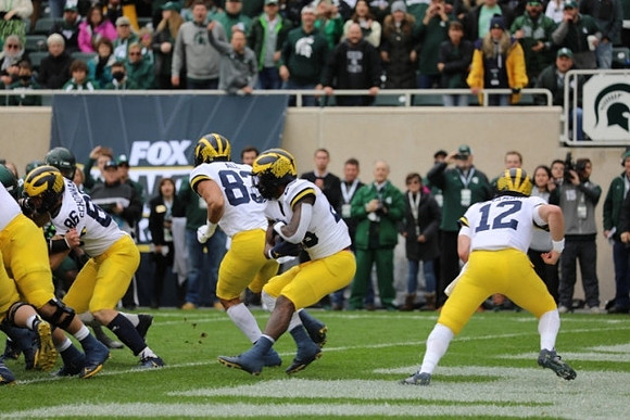 Luke Schoonmaker (86), Erick All (83), Hassan Haskins (25), and Cade McNamara (12)