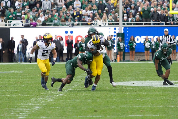 Blake Corum (2) and Erick All (83)