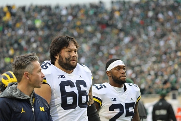Chuck Filiaga (66) and Hassan Haskins (25)