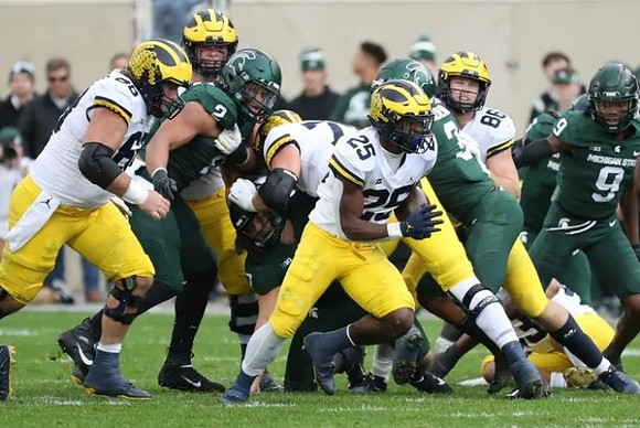 Chuck Filiaga (66), Hassan Haskins (25), and Luke Schoonmaker (86)