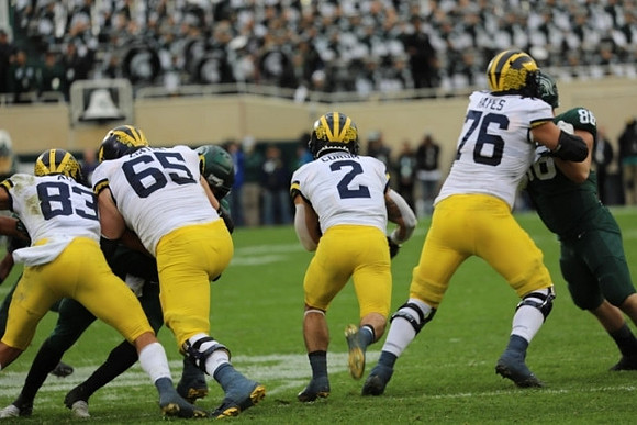 Erick All (83), Zak Zinter (65), Blake Corum (2), and Ryan Hayes (76)