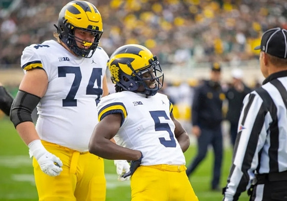 Reece Atteberry (74) and Mike Sainristil (5)