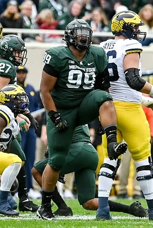 Hassan Haskins (25) and Ryan Hayes (76)