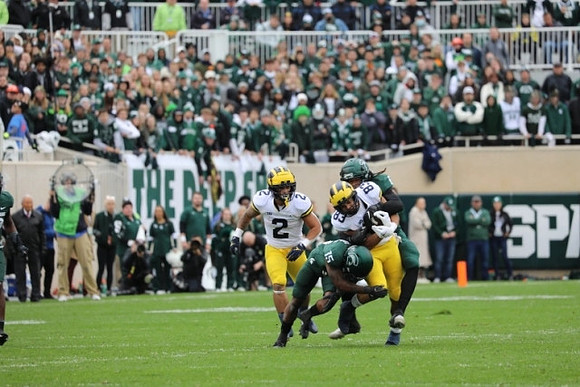 Blake Corum (2) and Erick All (83)