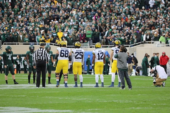 Andrew Vastardis (68), Hassan Haskins (25), Josh Ross (12), and Aidan Hutchinson (97)