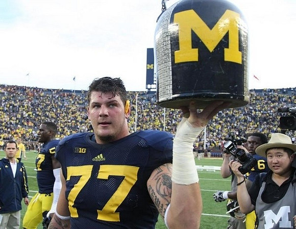 Taylor Lewan (77), Frank Clark (57), and Raymon Taylor (6)
