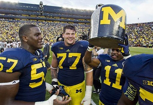 Frank Clark (57), Taylor Lewan (77), and Courtney Avery (11)