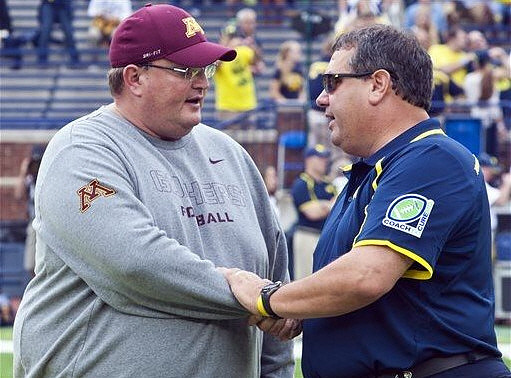 Minnesota Defensive Coordinator and Acting Head Coach Tracy Claey (Jerry Kill Out For Game) and Brady Hoke