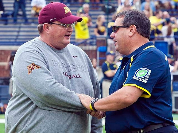 Minnesota Defensive Coordinator and Acting Head Coach Tracy Claey (Jerry Kill Out For Game) and Brady Hoke