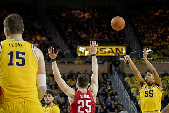 Jon Teske (15), Brandon Johns Jr. (23), and Eli Brooks (55)