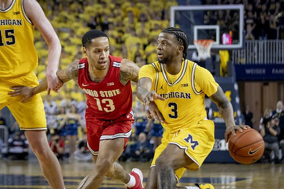 Jon Teske (15) and Zavier Simpson (3)