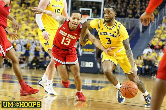 Jon Teske (15) and Zavier Simpson (3)