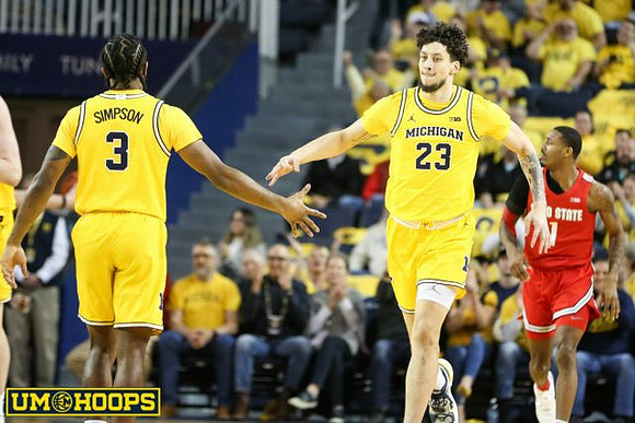 Zavier Simpson (3) and Brandon Johns Jr. (23)