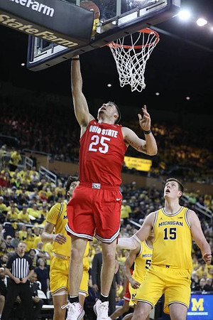 Brandon Johns Jr. (23), Eli Brooks (55), and Jon Teske (15)