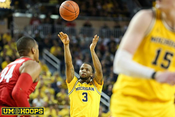 Zavier Simpson (3) and Jon Teske (15)