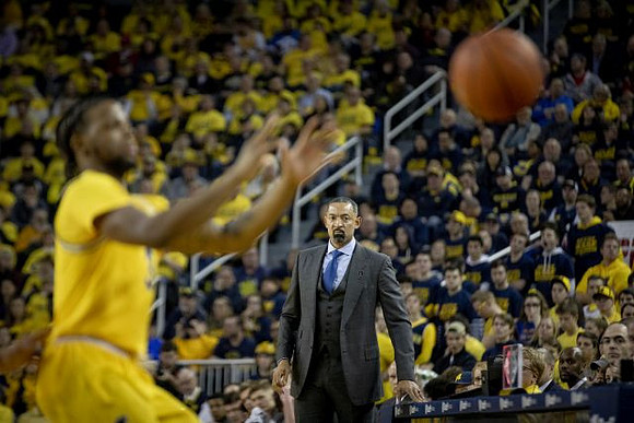Zavier Simpson (3) and Juwan Howard
