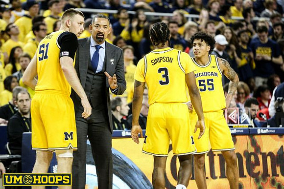 Austin Davis (51), Juwan Howard, Zavier Simpson (3), and Eli Brooks (55)