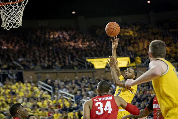 Zavier Simpson (3) and Jon Teske (15)