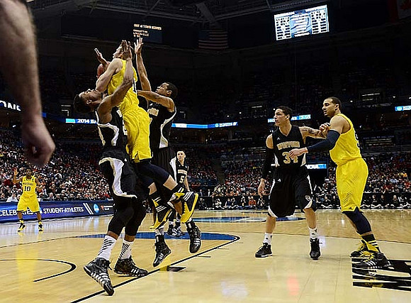 Derrick Walton Jr. (10), Nik Stauskas (11), and Jordan Morgan (52)